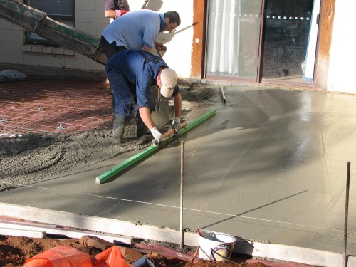 A new concrete slab being poured in our back yard.
